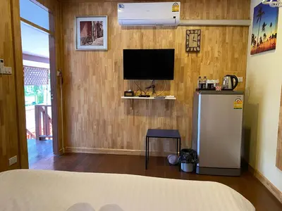 a room with a television on a wall at Bed in Beyt Boutique Hotel in Nonthaburi