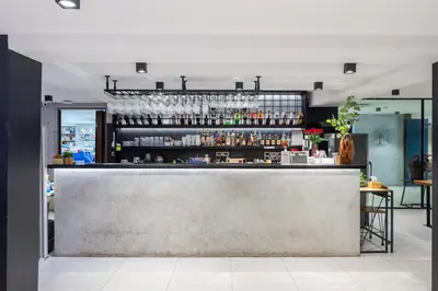 a bar in a restaurant with a counter at Loft Bangkok Hotel in Bangkok