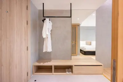 a room with a mirror and a dressing room with a bed at Loft Bangkok Hotel in Bangkok