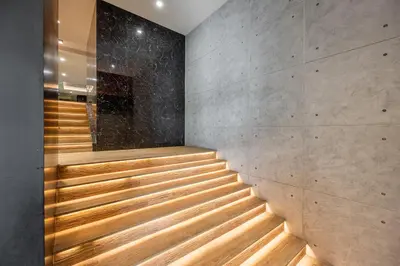 a staircase in a building with wood treads at Loft Bangkok Hotel in Bangkok