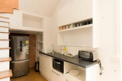 a kitchen with a microwave and a refrigerator at A Bangkok Journey in Bangkok