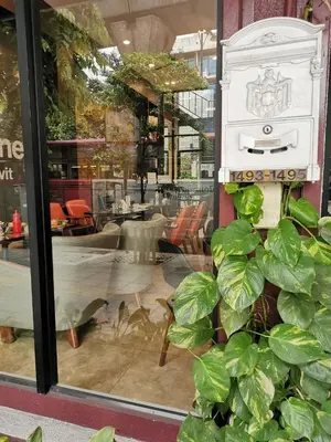 a plant in front of a window of a restaurant at A Bangkok Journey in Bangkok