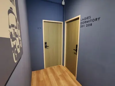 a room with two doors and a sign on the wall at A Bangkok Journey in Bangkok