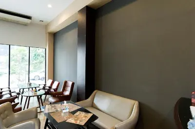 a living room with a couch and a table and chairs at A Bangkok Journey in Bangkok