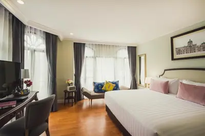 a hotel room with a bed and a television at Daraya Boutique Hotel in Bangkok