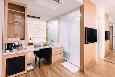 a room with a desk with a television and a counter at Artino Hotel Silom in Bangkok