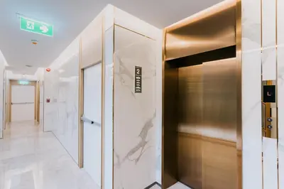 a hallway with a elevator in a building at Artino Hotel Silom in Bangkok