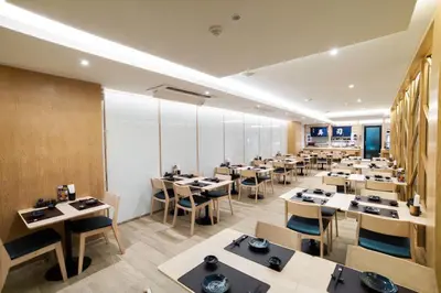 a large dining room with tables and chairs at Artino Hotel Silom in Bangkok