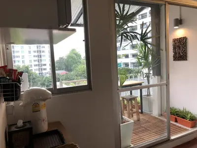 a room with two windows and a wooden deck at Pingplalee Female House in Bangkok