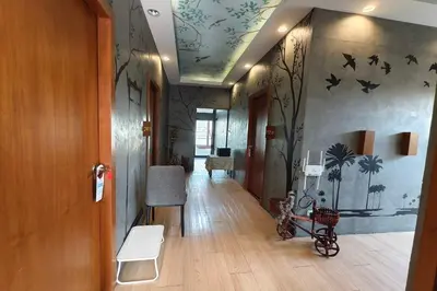 a hallway with a room with paintings on the ceilings at Lilliput Riverside Bangkachao in Samutprakarn