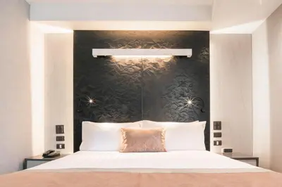 a bedroom with a large bed with a black wall at Aspira Gems Center Silom in Bangkok