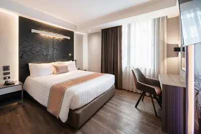 a hotel room with a bed and a desk at Aspira Gems Center Silom in Bangkok