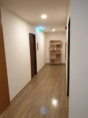 an empty room with a hallway with wooden floors at P18 Hotel Bangkok in Bangkok
