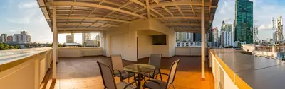 a balcony of a building with a table and chairs at P18 Hotel Bangkok in Bangkok