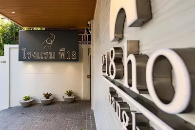 a sign on the side of a building with plants at P18 Hotel Bangkok in Bangkok