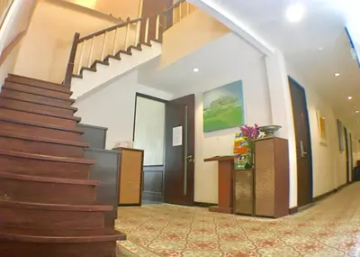 a hallway with a staircase in a building at Sabye Bangkok in Bangkok