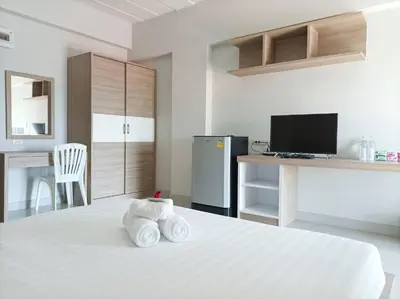 a bedroom with a white bed with towels on it at JVAPLACE in Nonthaburi