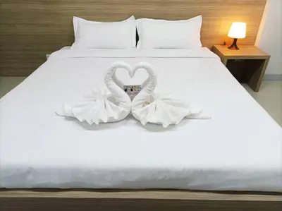 a bed with two swans shaped towels on it at JVAPLACE in Nonthaburi