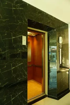 a hallway with a black marble wall with a mirror at JVAPLACE in Nonthaburi