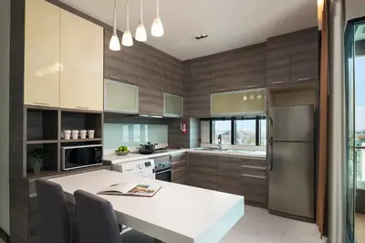 a kitchen with a white table and a refrigerator at Lumen Bangkok Srinakarin in Bangkok