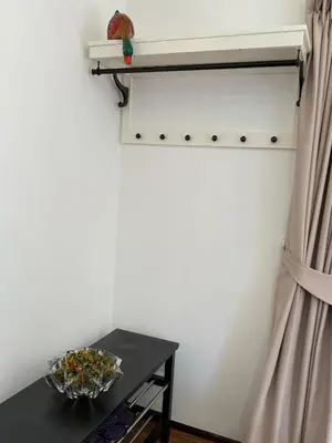 a corner of a room with a table and a curtain at Cozycomo Bangkok in Bangkok