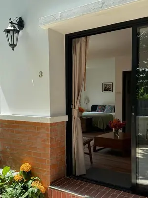a sliding glass door leading into a living room at Cozycomo Bangkok in Bangkok