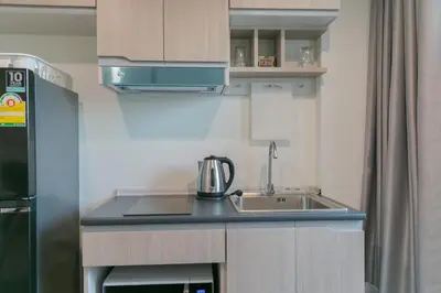 a small kitchen with a sink and a refrigerator at Moonlight Goddess in Bangkok