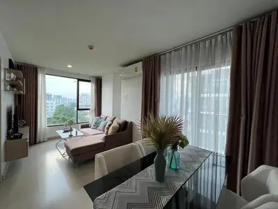 a living room with a couch and a table at Moonlight Goddess in Bangkok