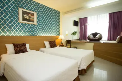 a hotel room with two beds and a window at P2 Boutique in Bangkok