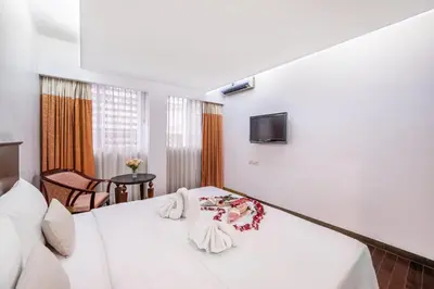 a hotel room with a bed and a tv at P2 Boutique in Bangkok