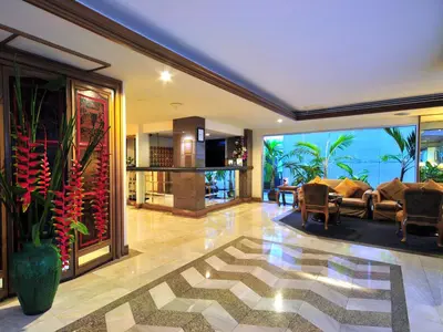 a living room with a couch and a table at Le Siam Hotel Silom Bangkok by PCL in Bangkok