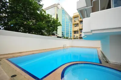 a large blue swimming pool on the side of a building at Le Siam Hotel Silom Bangkok by PCL in Bangkok