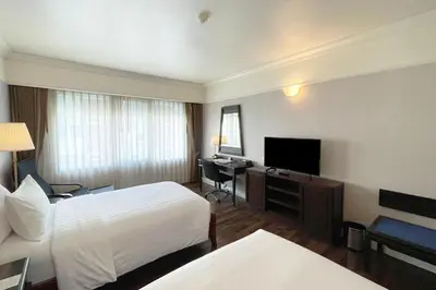 a hotel room with a bed and a flat screen tv at Le Siam Hotel Silom Bangkok by PCL in Bangkok