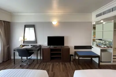 a hotel room with a desk and a television at Le Siam Hotel Silom Bangkok by PCL in Bangkok