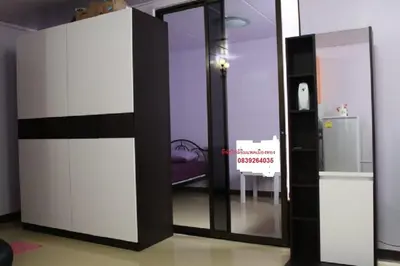 a room with a sliding glass door with a refrigerator at IMPACT Don Mueang Bangkok Guest House in Nonthaburi