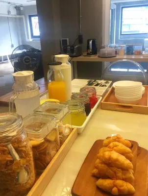 a kitchen counter with jars of food on a table at Siam Eco Hostel in Bangkok