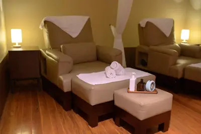 a room with a couch and a chair and a table at Town in Town Hotel Bangkok in Bangkok