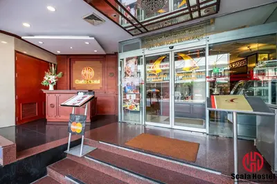 a store front with stairs in a building at Scala Hostel in Bangkok