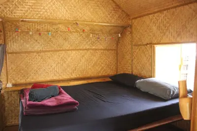 a room with two beds in a tiny house at Do Dee cafe in Bangkok