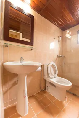 a bathroom with a sink and a toilet at Siam Palace Hotel in Bangkok