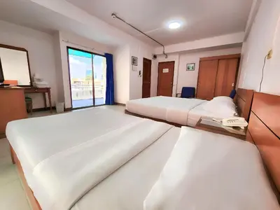 a hospital room with two beds and a window at Siam Palace Hotel in Bangkok