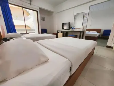 a hospital room with two beds and a mirror at Siam Palace Hotel in Bangkok