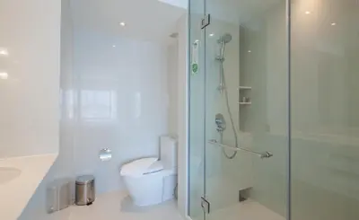 a bathroom with a glass shower and a toilet at Centara Watergate Pavilion Hotel Bangkok in Bangkok