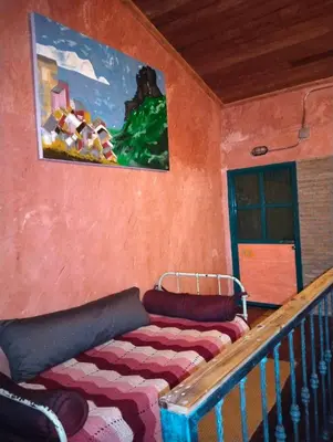 a room with a couch and a painting on the wall at Time Sabai 32 in Bangkok