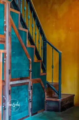 a painting of a wooden staircase in a room at Time Sabai 32 in Bangkok