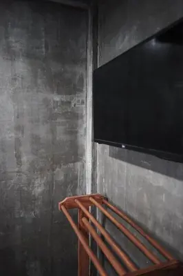 a flat screen tv hanging on a wall at THE HOG in Bangkok Yai