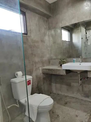 a bathroom with a toilet and a sink at THE HOG in Bangkok Yai