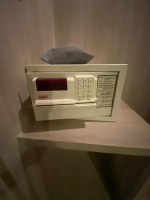 a toaster oven sitting on top of a shelf at Gold Orchid Bangkok Hotel in Bangkok