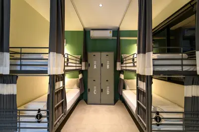 a room with three bunk beds in a building at Stay Wanglang in Bangkok