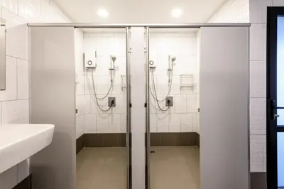 a bathroom with a shower and a sink at Stay Wanglang in Bangkok